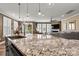 Spacious kitchen featuring granite countertops, stainless steel appliances, and seamless flow into the living area at 152 Blossom Ridge Dr, Mooresville, NC 28117