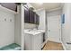 Convenient laundry room featuring a washer, dryer, and storage cabinets at 152 Blossom Ridge Dr, Mooresville, NC 28117