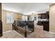Spacious loft area with dark cabinets, a wet bar, and comfortable seating for movie watching at 152 Blossom Ridge Dr, Mooresville, NC 28117