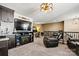 Open loft space with a TV, electric fireplace, dark brown cabinetry, and leather recliners at 152 Blossom Ridge Dr, Mooresville, NC 28117