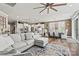 Bright living room open to a spacious kitchen and dining area, featuring a large sectional couch and modern decor at 152 Blossom Ridge Dr, Mooresville, NC 28117