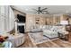 Cozy living room with fireplace, ceiling fan, large sectional couch, and decorative rug at 152 Blossom Ridge Dr, Mooresville, NC 28117