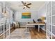 Stylish home office with French doors, wood floors, and a ceiling fan providing a functional workspace at 152 Blossom Ridge Dr, Mooresville, NC 28117