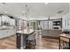 Open concept living with a kitchen island, dining area, and living room providing ample space for gatherings at 152 Blossom Ridge Dr, Mooresville, NC 28117