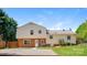 Backyard featuring a mix of brick and siding, patio, lawn, mature trees, and fence at 1637 Buckingham Ave, Gastonia, NC 28054