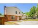Backyard featuring a mix of brick and siding, patio, lawn, mature trees, and fence at 1637 Buckingham Ave, Gastonia, NC 28054