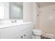 Clean bathroom featuring a shower and tub combination, with a modern vanity and white tile at 1637 Buckingham Ave, Gastonia, NC 28054