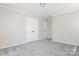 Neutral carpeted bedroom featuring closet space and a ceiling fan at 1637 Buckingham Ave, Gastonia, NC 28054