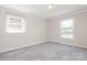 Bright, airy bedroom featuring neutral walls, carpet, and natural light from two windows at 1637 Buckingham Ave, Gastonia, NC 28054