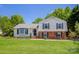 Charming two-story home with lush green lawn, manicured landscaping, and inviting front porch at 1637 Buckingham Ave, Gastonia, NC 28054
