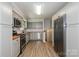 Renovated kitchen featuring stainless steel appliances, wood countertops, and modern gray cabinetry at 1637 Buckingham Ave, Gastonia, NC 28054