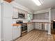 Updated kitchen featuring butcher block countertops, modern stainless steel appliances, and gray cabinets at 1637 Buckingham Ave, Gastonia, NC 28054