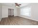 Bright living room featuring wood-look floors, a ceiling fan, and a large bay window at 1637 Buckingham Ave, Gastonia, NC 28054