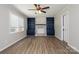 Bright living room featuring a brick fireplace, custom built-ins, and wood-look flooring at 1637 Buckingham Ave, Gastonia, NC 28054