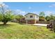 Spacious backyard with lush lawn, a wooden deck, and partial fencing at 1766 Colony Rd, Rock Hill, SC 29730