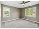 Bedroom with neutral walls, plush carpet, and two windows offering outdoor views at 1766 Colony Rd, Rock Hill, SC 29730