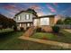 Charming two-story home with brick and vinyl siding, complemented by a well-manicured lawn and landscaped yard at 1766 Colony Rd, Rock Hill, SC 29730