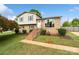 Charming two-story home with brick and vinyl siding, complemented by a well-manicured lawn and landscaped yard at 1766 Colony Rd, Rock Hill, SC 29730