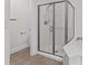 Bright and clean bathroom with a tiled standup shower, white walls, neutral tile floor and minimal fixtures at 18700 Nautical Dr # 203, Cornelius, NC 28031