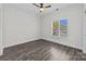 A serene bedroom with wood-look floors, neutral walls, and a window with bright, natural light at 18700 Nautical Dr # 203, Cornelius, NC 28031