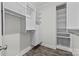 Bright walk-in closet with custom shelving, drawers, and hardwood floors providing ample storage space at 18700 Nautical Dr # 203, Cornelius, NC 28031