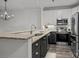 Modern kitchen with stainless steel appliances, stone countertops, and stylish cabinets creating a functional space at 18700 Nautical Dr # 203, Cornelius, NC 28031