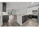 Modern kitchen with stainless steel appliances, an island, and opens to a living area at 18700 Nautical Dr # 203, Cornelius, NC 28031