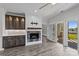 Bright living area featuring a fireplace, custom built-ins, and an open view to the balcony at 18700 Nautical Dr # 203, Cornelius, NC 28031