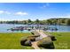 Picturesque waterfront marina featuring boat slips, lush landscaping, and scenic views of the lake and surrounding area at 18700 Nautical Dr # 203, Cornelius, NC 28031