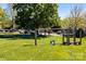 Playground on a lush green lawn with mature trees and ample space for recreational activities at 18700 Nautical Dr # 203, Cornelius, NC 28031