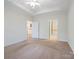 Bedroom with carpet, open doorways leading to other rooms, and ample natural light at 1910 Mezzo Ct, Matthews, NC 28105