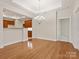 Open dining area featuring hardwood floors, chandelier lighting, and a seamless transition to the kitchen at 1910 Mezzo Ct, Matthews, NC 28105