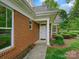 Charming front door and entryway with brick and stone exterior, plus manicured landscaping at 1910 Mezzo Ct, Matthews, NC 28105