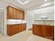 Spacious kitchen area with granite countertops, tile flooring, and warm wooden cabinetry at 1910 Mezzo Ct, Matthews, NC 28105
