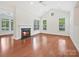 Bright living room boasts vaulted ceiling, fireplace, hardwood floors, and plentiful natural light at 1910 Mezzo Ct, Matthews, NC 28105
