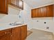 Clean utility area featuring a sink, cabinets, and easy connections for laundry appliances at 1910 Mezzo Ct, Matthews, NC 28105