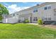 Spacious backyard with a grassy lawn, patio, and privacy fence at 2059 Lennox Square Rd, Charlotte, NC 28210