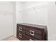 A well-organized walk-in closet with shelving and a chest of drawers, providing ample storage space at 2059 Lennox Square Rd, Charlotte, NC 28210