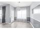 Dining area featuring modern light fixture, grey wainscoting and light plank floors at 2059 Lennox Square Rd, Charlotte, NC 28210