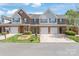 Townhome with brick and siding exterior, green shutters, and an attached garage at 2059 Lennox Square Rd, Charlotte, NC 28210