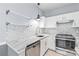 Well-lit kitchen with stainless steel appliances, marble countertops, and white cabinets at 2059 Lennox Square Rd, Charlotte, NC 28210