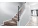 Carpeted staircase with white railings and dark wood accents at 2059 Lennox Square Rd, Charlotte, NC 28210