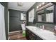 Stylish bathroom featuring a dark green wall color, unique backsplash, and framed mirror at 211 Hershel Lackey Rd, Lincolnton, NC 28092