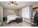 Comfortable bedroom featuring wood floors, a ceiling fan, and a window for natural light at 211 Hershel Lackey Rd, Lincolnton, NC 28092