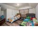 Cozy ' bedroom with two twin beds, wooden floors, and a window with curtains at 211 Hershel Lackey Rd, Lincolnton, NC 28092