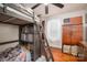 ' bedroom featuring a bunk bed with built-in storage, wood floors, and natural light from the window at 211 Hershel Lackey Rd, Lincolnton, NC 28092