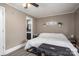 Cozy bedroom featuring neutral walls, hardwood floors, a ceiling fan, and a connecting bathroom at 211 Hershel Lackey Rd, Lincolnton, NC 28092