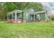 Charming green two-story home with a brick foundation and a welcoming porch at 211 Hershel Lackey Rd, Lincolnton, NC 28092