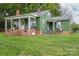 Charming green home with a welcoming front porch and well-maintained lawn at 211 Hershel Lackey Rd, Lincolnton, NC 28092