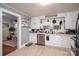 Charming kitchen featuring white cabinets, stainless steel appliances, and a view to a dining area at 211 Hershel Lackey Rd, Lincolnton, NC 28092